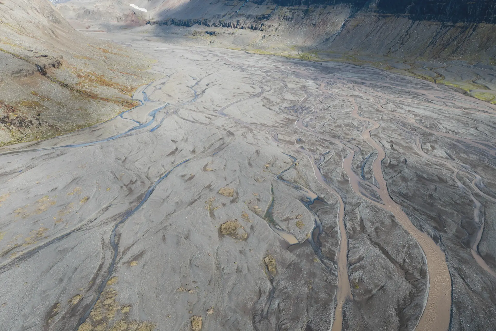 Aerial view of a braided river through a rocky valley